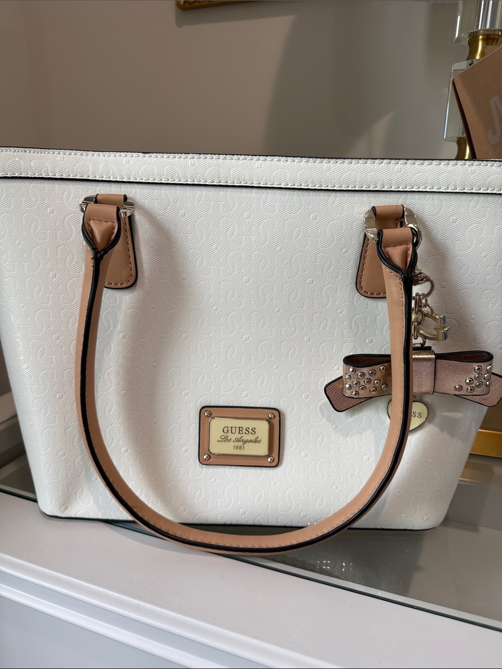 Guess White Tote with Tan Trim and Bow Charm